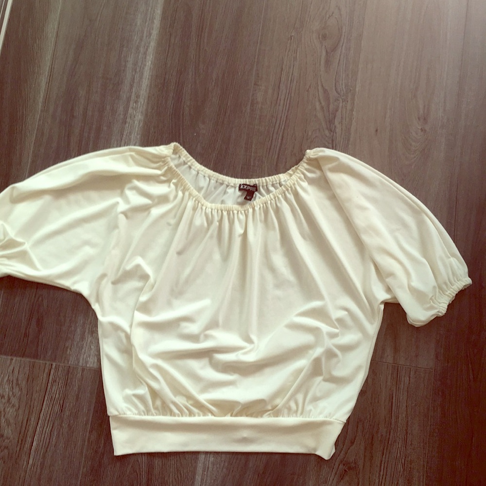 Off the shoulders cream blouse.